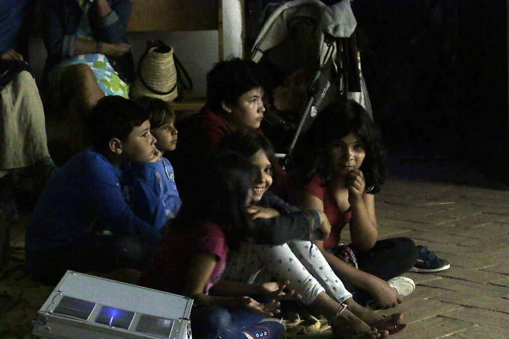 Les enfants devant l'écran à la projection du Plein de Super de Raposeira